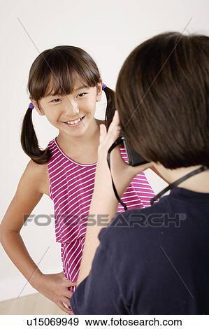 Boy (10-11) taking photo of girl (10-11), studio shot View Large Photo Image Stock Photo - Boy (10-11) taking photo of girl (10-11), studio shot. Fotosearch