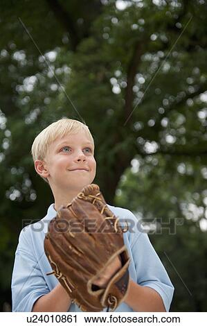 Boy (10-11) wearing baseball glove View Large Photo Image Stock Image - Boy (10-11) wearing baseball glove. Fotosearch