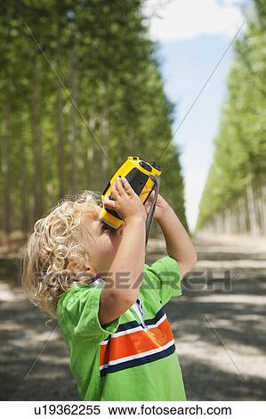 Boy (2-3) looking through binoculars View Large Photo Image Stock Photography - Boy (2-3) looking through binoculars. Fotosearch