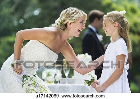 Bride with flower girl (10-11) at wedding reception View Large Photo Image Stock Photo - Bride with flower girl (10-11) at wedding reception. Fotosearch