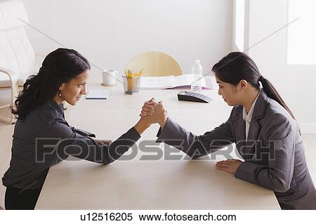 Business man and business woman armwrestling View Large Photo Image Stock Photography - Business man and business woman armwrestling. Fotosearch