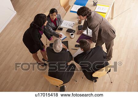 Stock Photo - Business meeting, high angle view. Fotosearch