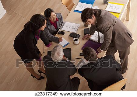Stock Photo - Business meeting, high angle view. Fotosearch