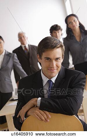 Stock Image - Business people in office looking at camera. Fotosearch