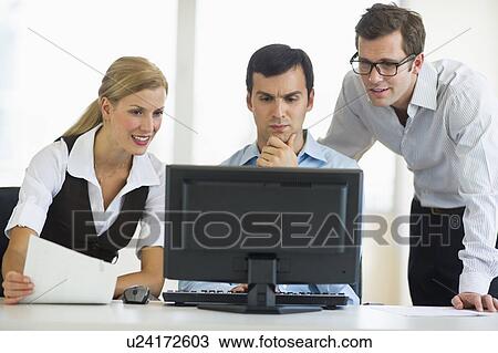 Business team looking at computer View Large Photo Image Stock Image - Business team looking at computer. Fotosearch