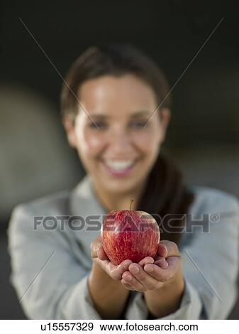 Business woman holding apple View Large Photo Image Stock Photo - Business woman holding apple. Fotosearch