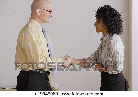 Businessman and businesswoman handshake during meeting View Large Photo Image Stock Image - Businessman and businesswoman handshake during meeting. Fotosearch