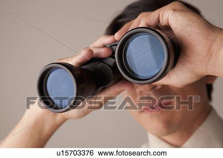 Businessman looking through binoculars View Large Photo Image Stock Photograph - Businessman looking through binoculars. Fotosearch