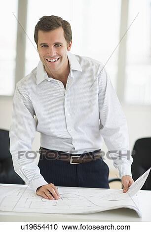 Businessman reading blueprint View Large Photo Image Stock Image - Businessman reading blueprint. Fotosearch