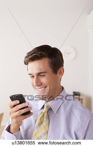 Businessman text-messaging View Large Photo Image Stock Photography - Businessman text-messaging. Fotosearch