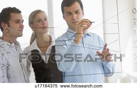 Businessman writing on transparent board View Large Photo Image Stock Photography - Businessman writing on transparent board. Fotosearch