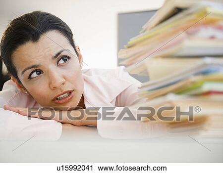Businesswoman overworked with paperwork View Large Photo Image Stock Image - Businesswoman overworked with paperwork. Fotosearch