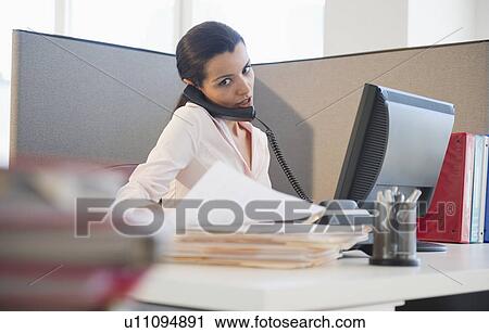 Businesswoman working at desk in office View Large Photo Image Stock Image - Businesswoman working at desk in office. Fotosearch