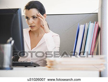 Businesswoman working at desk in office View Large Photo Image Stock Photo - Businesswoman working at desk in office. Fotosearch
