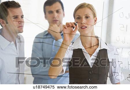 Businesswoman writing on transparent board View Large Photo Image Stock Photography - Businesswoman writing on transparent board. Fotosearch