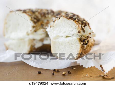 Picture - Close up of bagel with cream cheese. Fotosearch
