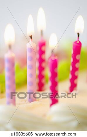 Stock Photograph - Close-up of birthday candles on cake. Fotosearch