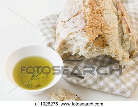 Close up of bread and olive oil on table View Large Photo Image Stock Photography - Close up of bread and olive oil on table. Fotosearch