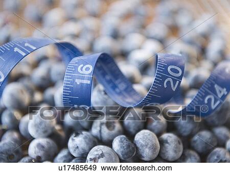 Close up of frozen blueberries in jar and measuring tape View Large Photo Image Stock Photo - Close up of frozen blueberries in jar and measuring tape. Fotosearch