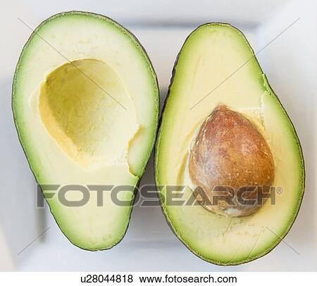 Close up of halves of avocado View Large Photo Image Stock Photo - Close up of halves of avocado. Fotosearch