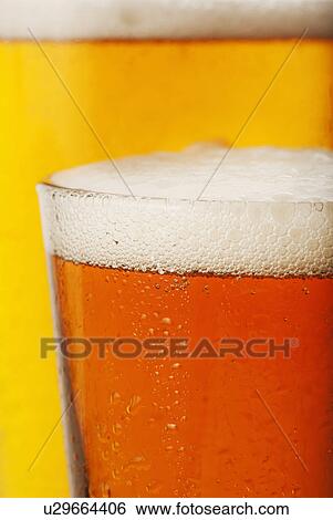Close-up of lager in glass View Large Photo Image Stock Photograph - Close-up of lager in glass. Fotosearch