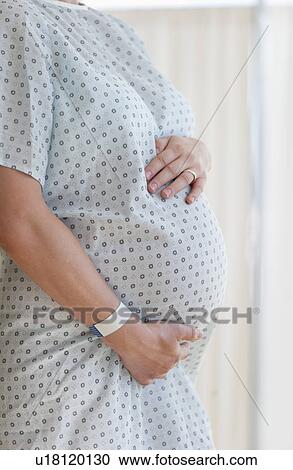 Close-up of pregnant woman in hospital View Large Photo Image Stock Image - Close-up of pregnant woman in hospital. Fotosearch