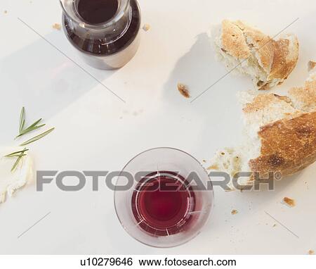 Close up of red wine and bread on table View Large Photo Image Stock Photograph - Close up of red wine and bread on table. Fotosearch