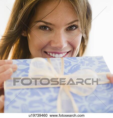 Close up of smiling woman with gift View Large Photo Image Stock Image - Close up of smiling woman with gift. Fotosearch