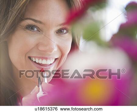 Stock Photograph - Close up of smiling woman with lipstick. Fotosearch
