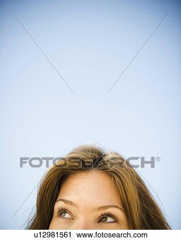 Close up of woman's head on blue background View Large Photo Image Stock Image - Close up of woman's head on blue background. Fotosearch