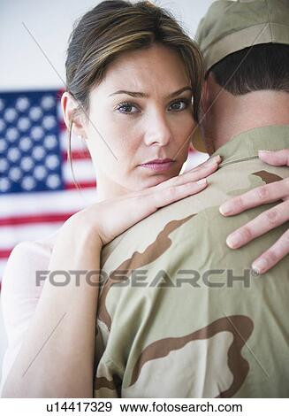 Stock Photo - Close up woman embracing soldier during farewell. Fotosearch