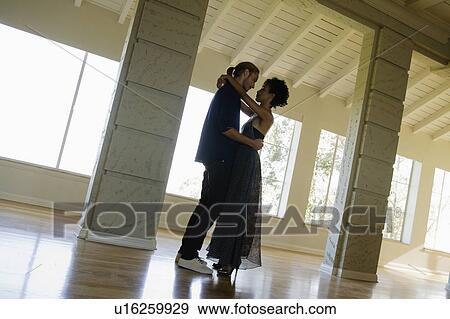 Couple dancing in empty room View Large Photo Image Stock Photo - Couple dancing in empty room. Fotosearch