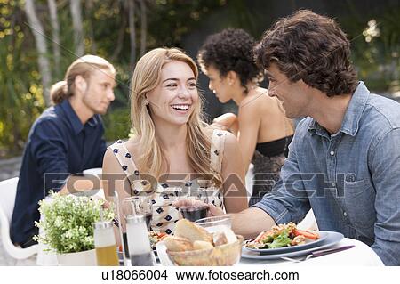 Picture - Couple dining in outdoor restaurant. Fotosearch