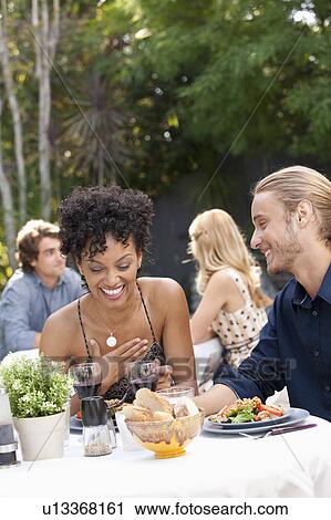 Couple dining in outdoor restaurant View Large Photo Image Stock Image - Couple dining in outdoor restaurant. Fotosearch