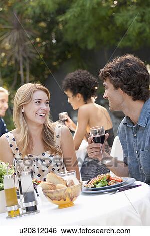 Stock Photograph - Couple dining in outdoor restaurant. Fotosearch