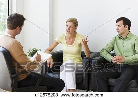 Stock Photo - Couple discussing issues during therapy. Fotosearch