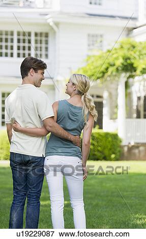 Couple in front of house View Large Photo Image Stock Photo - Couple in front of house. Fotosearch