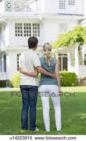 Stock Photography - Couple in front of house. Fotosearch
