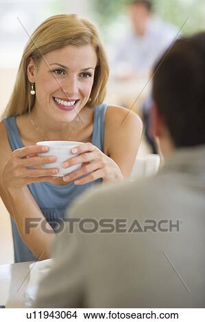 Couple talking in coffee shop View Large Photo Image Picture - Couple talking in coffee shop. Fotosearch