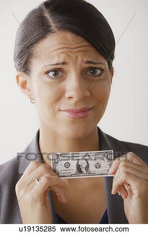 Disappointment businesswoman holding one dollar note, studio shot View Large Photo Image Stock Photography - Disappointment businesswoman holding one dollar note, studio shot. Fotosearch