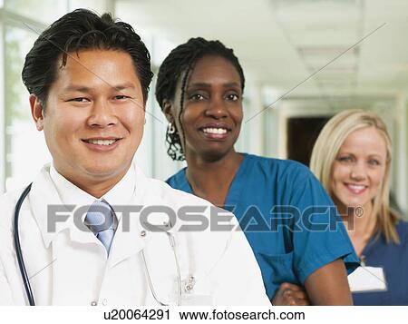 Stock Image - Doctor and two nurses posing for portrait. Fotosearch
