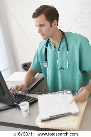 Stock Image - Doctor using computer. Fotosearch