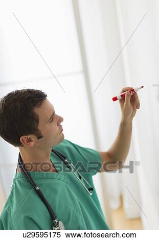 Doctor writing on whiteboard View Large Photo Image Stock Photography - Doctor writing on whiteboard. Fotosearch