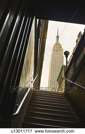 Stock Photo - Empire State Building as seen from subway station staircase. Fotosearch