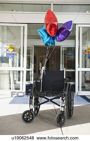 Empty wheelchair with bunch of balloons View Large Photo Image Stock Photo - Empty wheelchair with bunch of balloons. Fotosearch