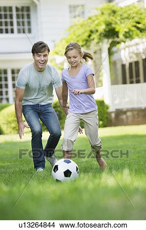 Father and daughter (10-11) playing soccer View Large Photo Image Picture - Father and daughter (10-11) playing soccer. Fotosearch