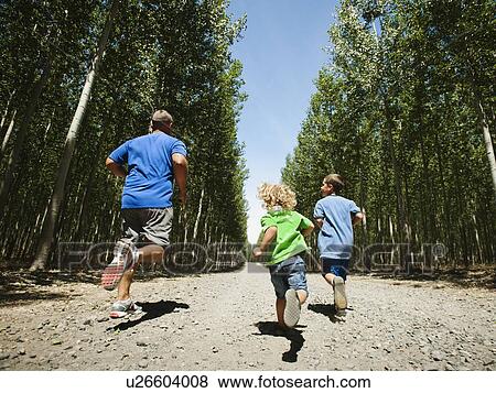 Father with sons (2-9) running up country road View Large Photo Image Stock Photo - Father with sons (2-9) running up country road. Fotosearch