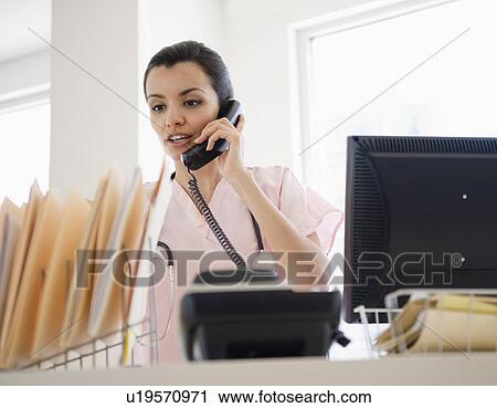 Female receptionist in hospital View Large Photo Image Stock Image - Female receptionist in hospital. Fotosearch