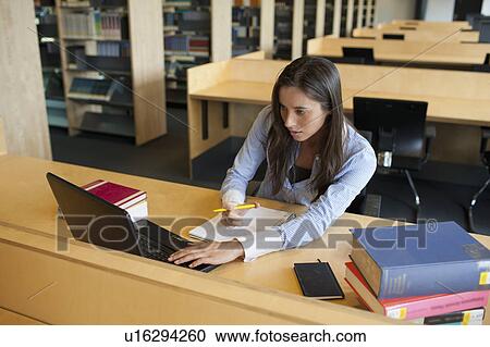 Female student studying in library View Large Photo Image Stock Image - Female student studying in library. Fotosearch