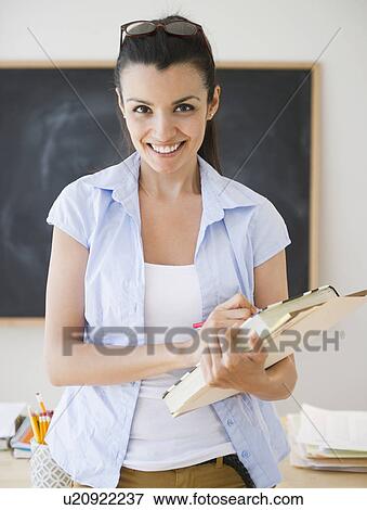 Female teacher in classroom View Large Photo Image Stock Photo - Female teacher in classroom. Fotosearch